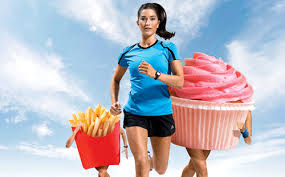 Woman running followed by cupcake and box of french fries