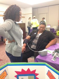 Patient checks blood pressure during Care2BWell event