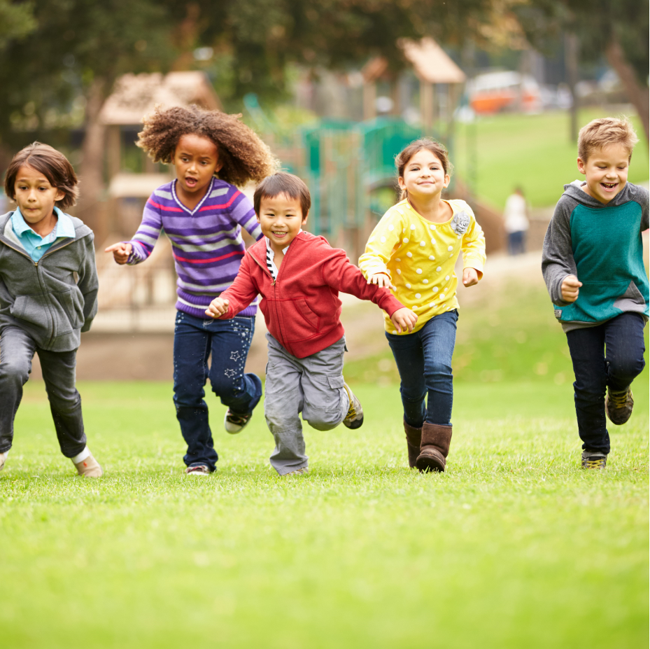 Photo of kids running near a playground.