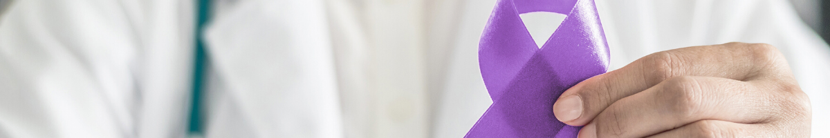 Doctor holding a purple ribbon for cancer awareness