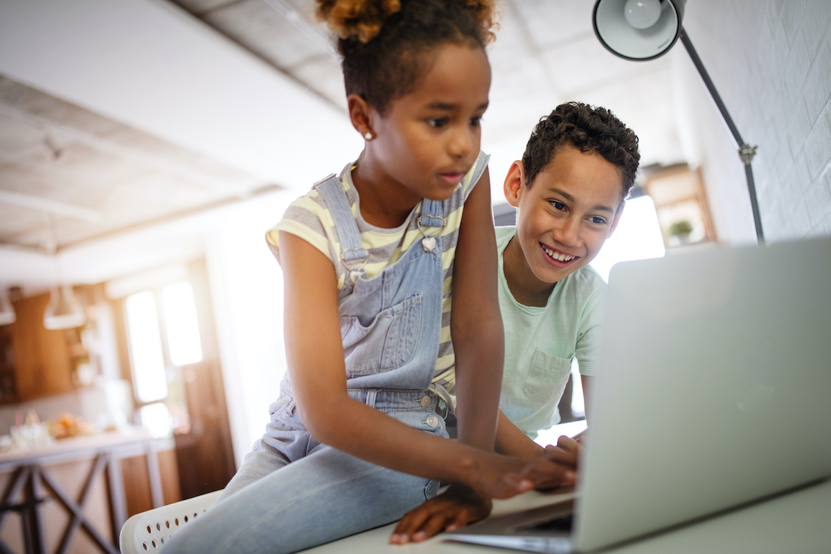 Two children using a laptop
